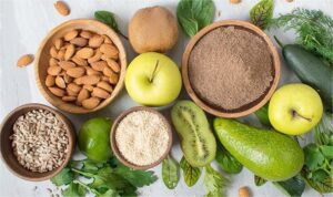 Almonds ,green apple,kiwi are placed on table